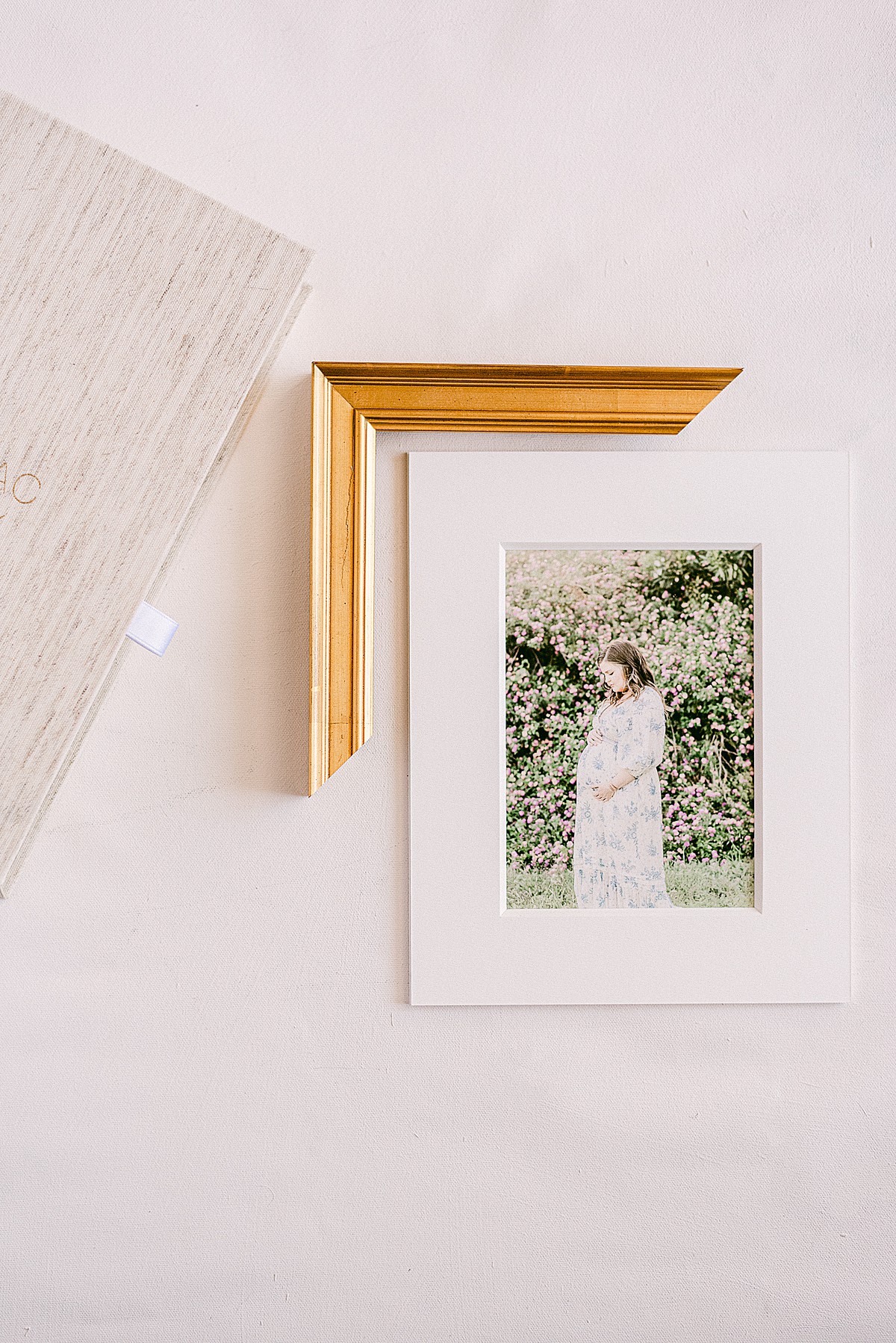 matted print of maternity photoshoot paired with frame moulding