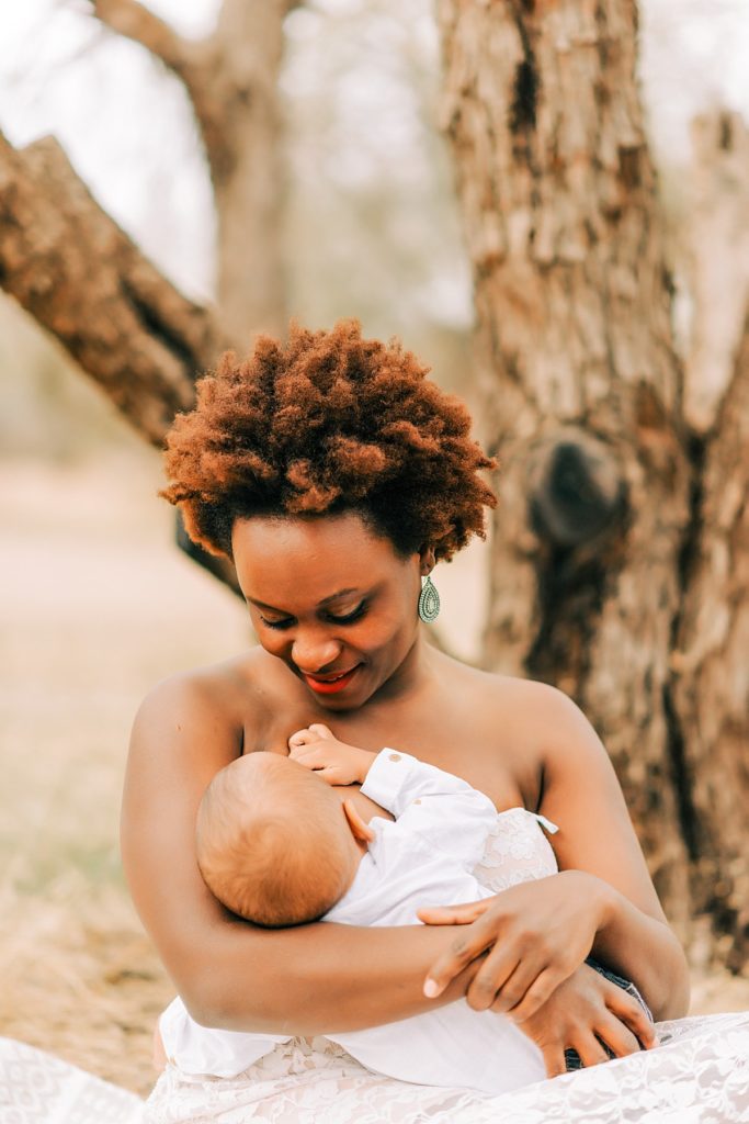 mom gazing at baby boy while breastfeeding