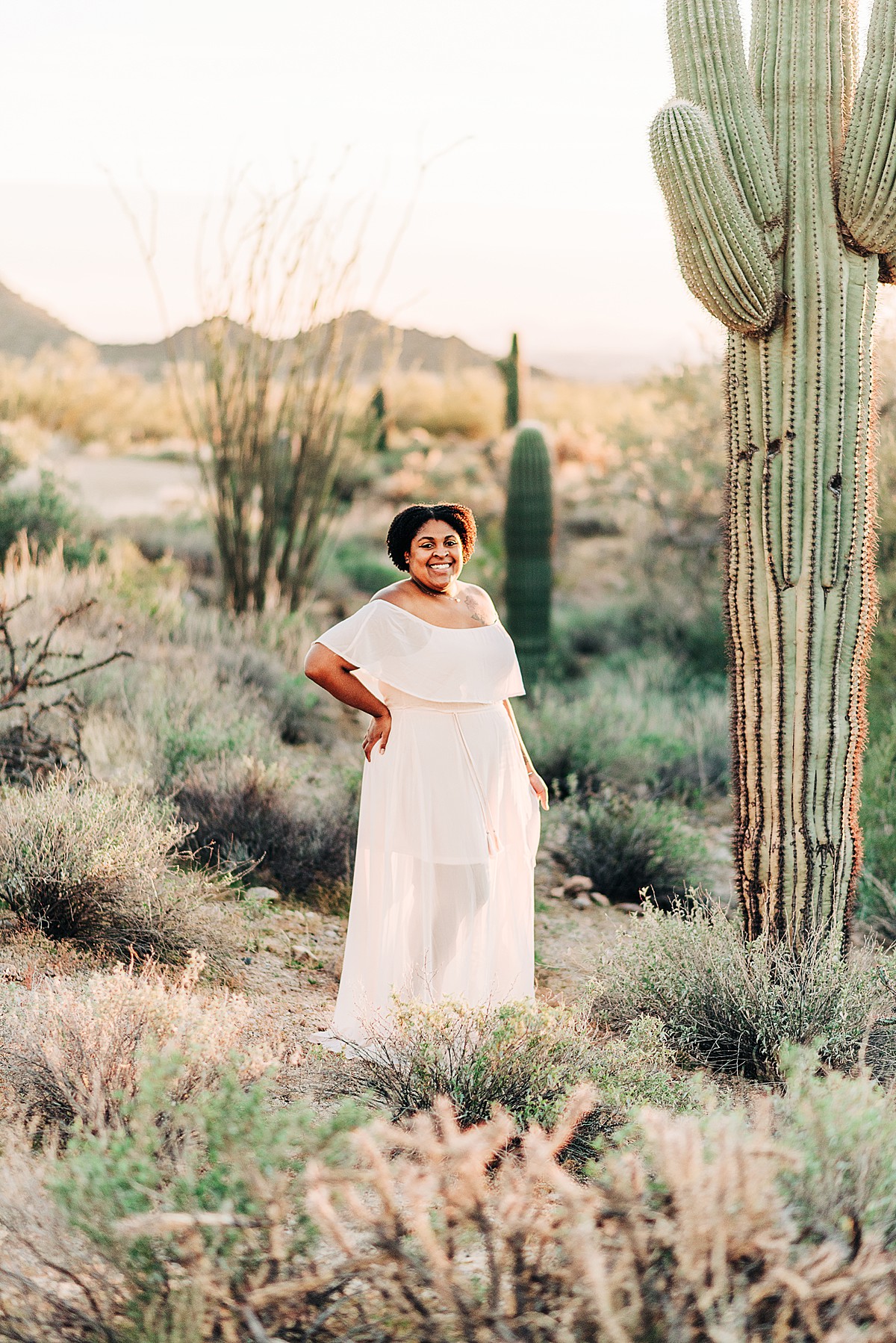 arizona family photographer Jasmyn Coleman in blush pink dress by saguaro cactus