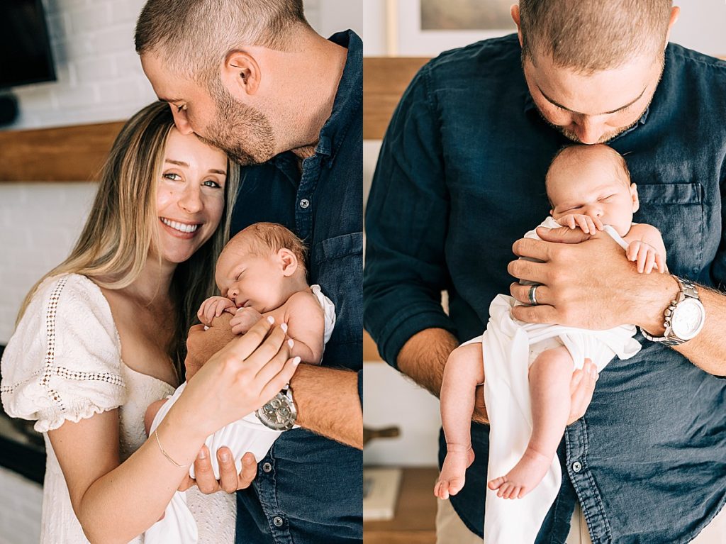 New dad kissing head of newborn baby and mom while in home