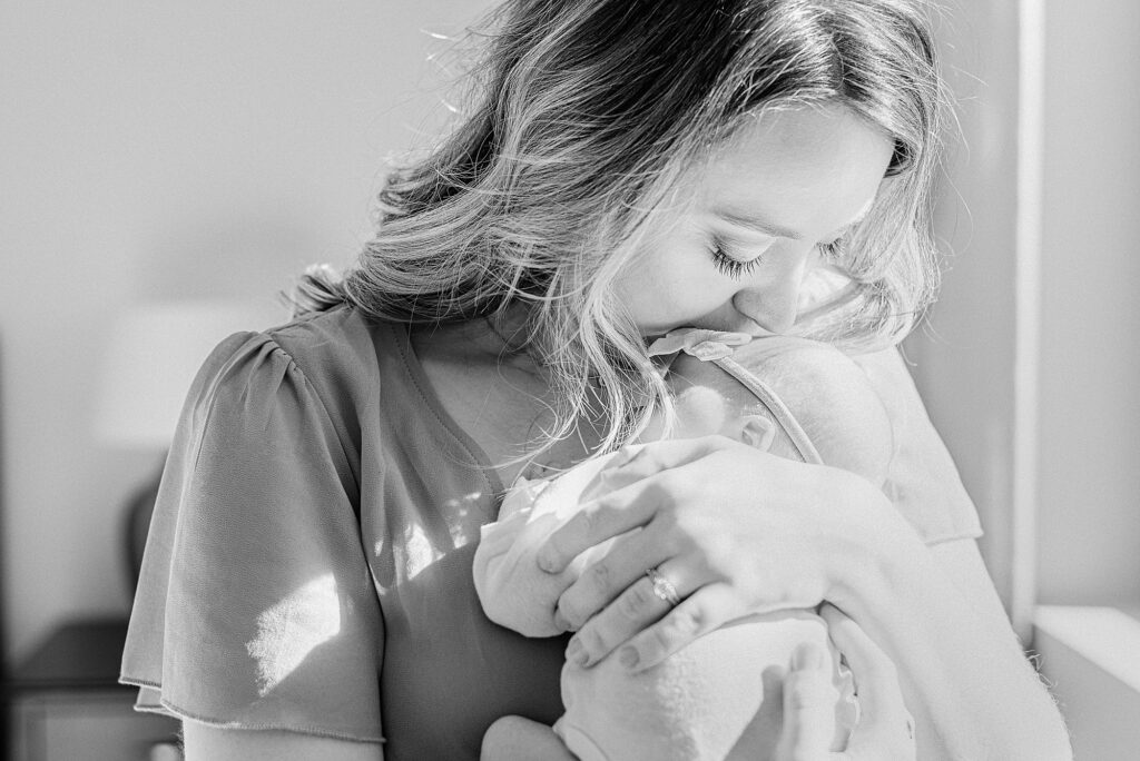 Scottsdale mom snuggling newborn baby girl's forhead