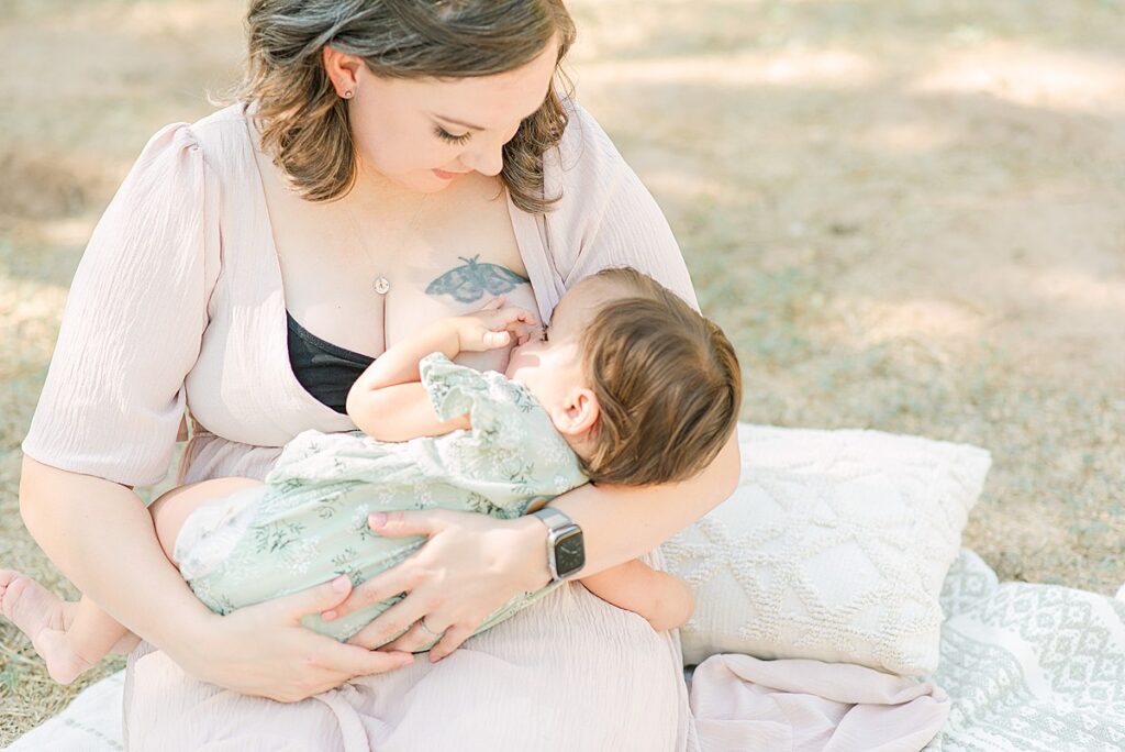 Toddler cradling mom while laying in lap while she's being breastfed.