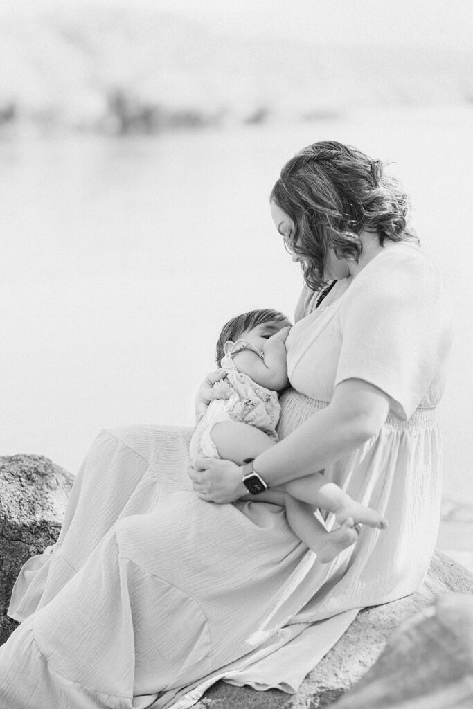 Mom and baby in front of Salt River while breastfeeding for nostalgic and emotive session