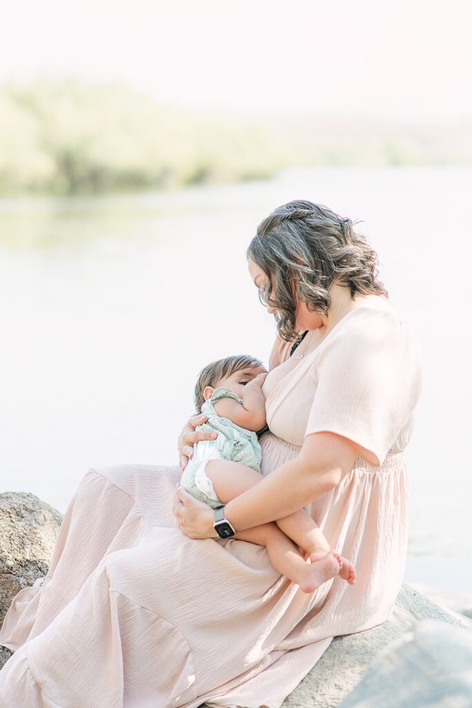 Endearing photo of a mother breastfeeding her toddler. They are at scenic Salt River, AZ