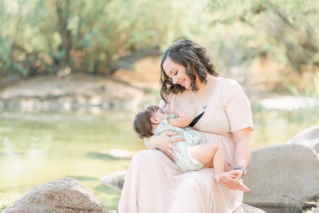Mom with daughter in laughter out at the Salt River for a breastfeeding photoshoot