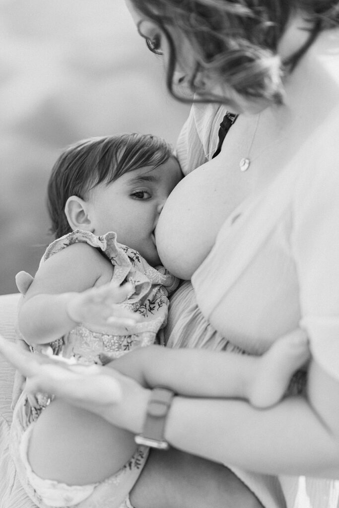 Baby breastfeeding while making eye contact with camera.