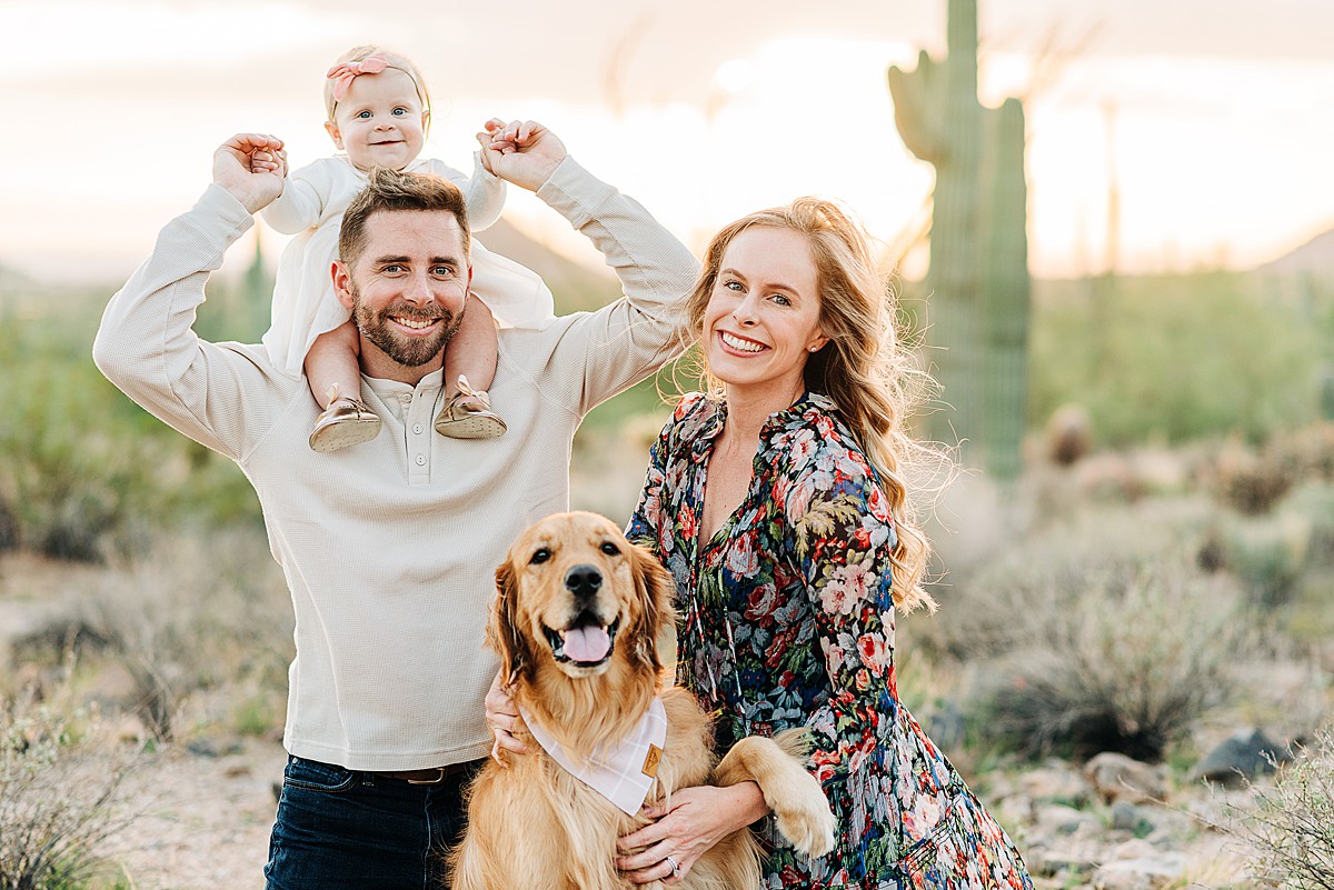 Phoenix family in desert with dog. Dad is holding baby on his shoulders.