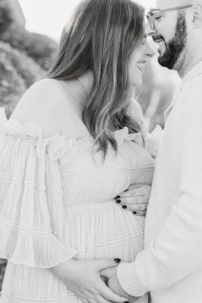 Expecting couple laughing during their Scottsdale babymoon for desert maternity photoshoot