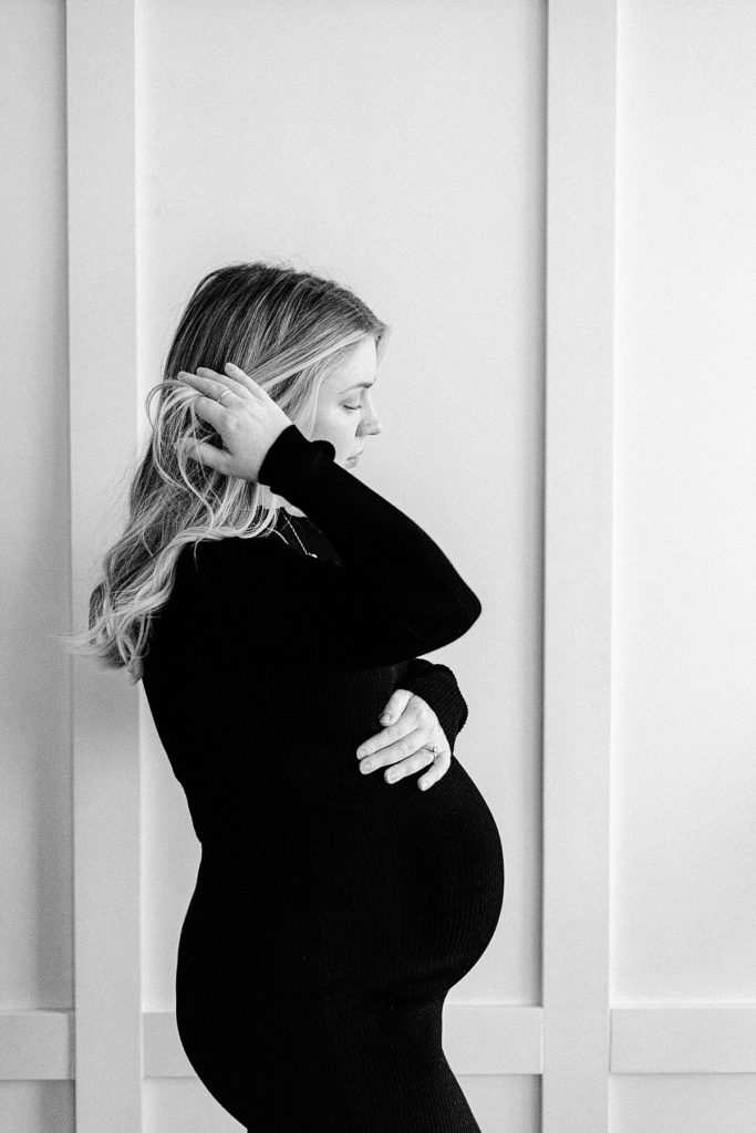 black and white silhouette of mom in third trimester running fingers through hair