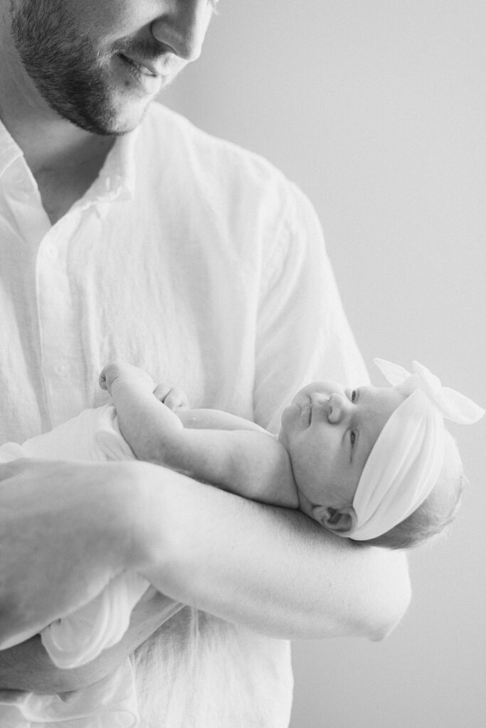 dad gazing at newborn baby girl