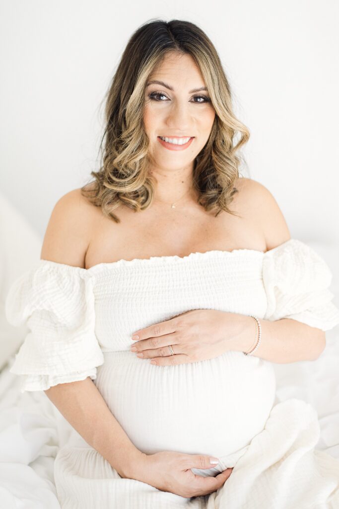 pregnant mom has professional hair and makeup for studio maternity photos