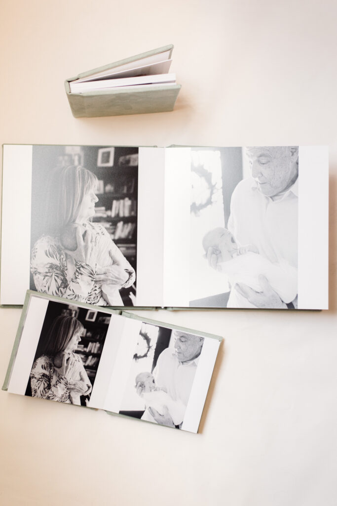 open spread of grandparents on each page of newborn family photo album paired with "grandparent mini" duplicate albums